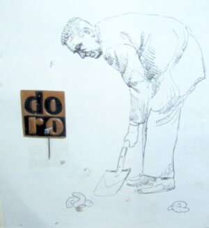 Plakietka metalowa PRL z napisem Dobra Robota i satyrycznym rysunkiem autorstwa Jacka Kilińskiego