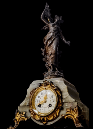 Zabytkowy francuski zegar kominkowy z XIX wieku z odlaną figurą skrzydlatej bogini Nike trzymającej miecz.