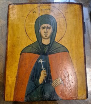 Ikona prawosławna z XIX wieku przedstawiająca świętą kobietę w habicie z krzyżem w dłoni