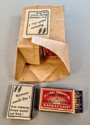 Przedwojenne polskie pudełko zapałek z niemieckim nadrukiem okupacyjnym i reklamą SS, okres II wojny światowej.